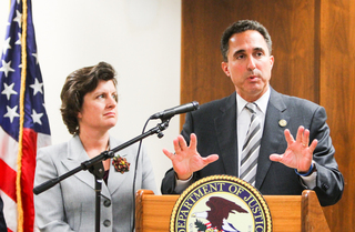U.S. Attorney Richard Hartunian speaks Thursday as Syracuse Mayor Stephanie Miner looks on. The U.S. Department of Justice granted the Syracuse community $300,000 to put toward gang prevention.